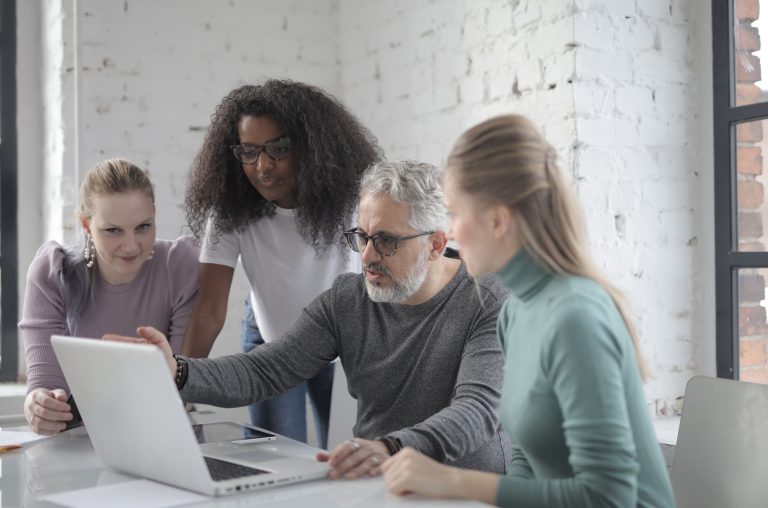 Diverse young professionals collaborate on a project, symbolizing interdisciplinary teamwork