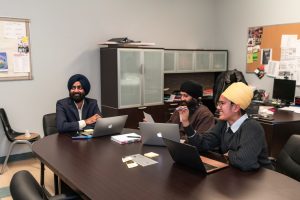 Young leaders collaborate on a project, symbolizing innovation and future leadership