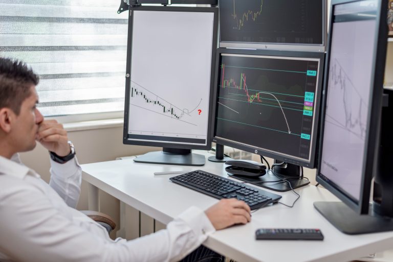 Trading floor with market data and financial charts