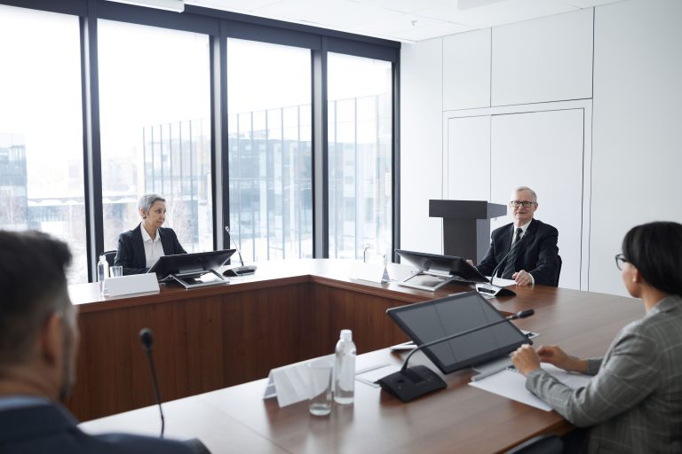 People sit around a conference table during a discussion