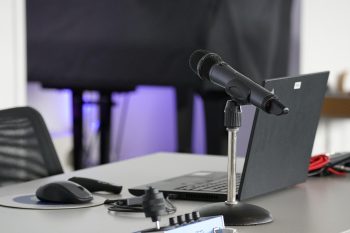Laptop, conference table, mouse, and work